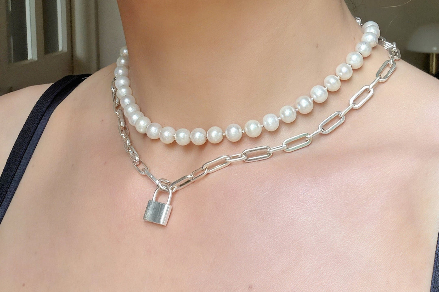 woman wearing chain and pearl necklace