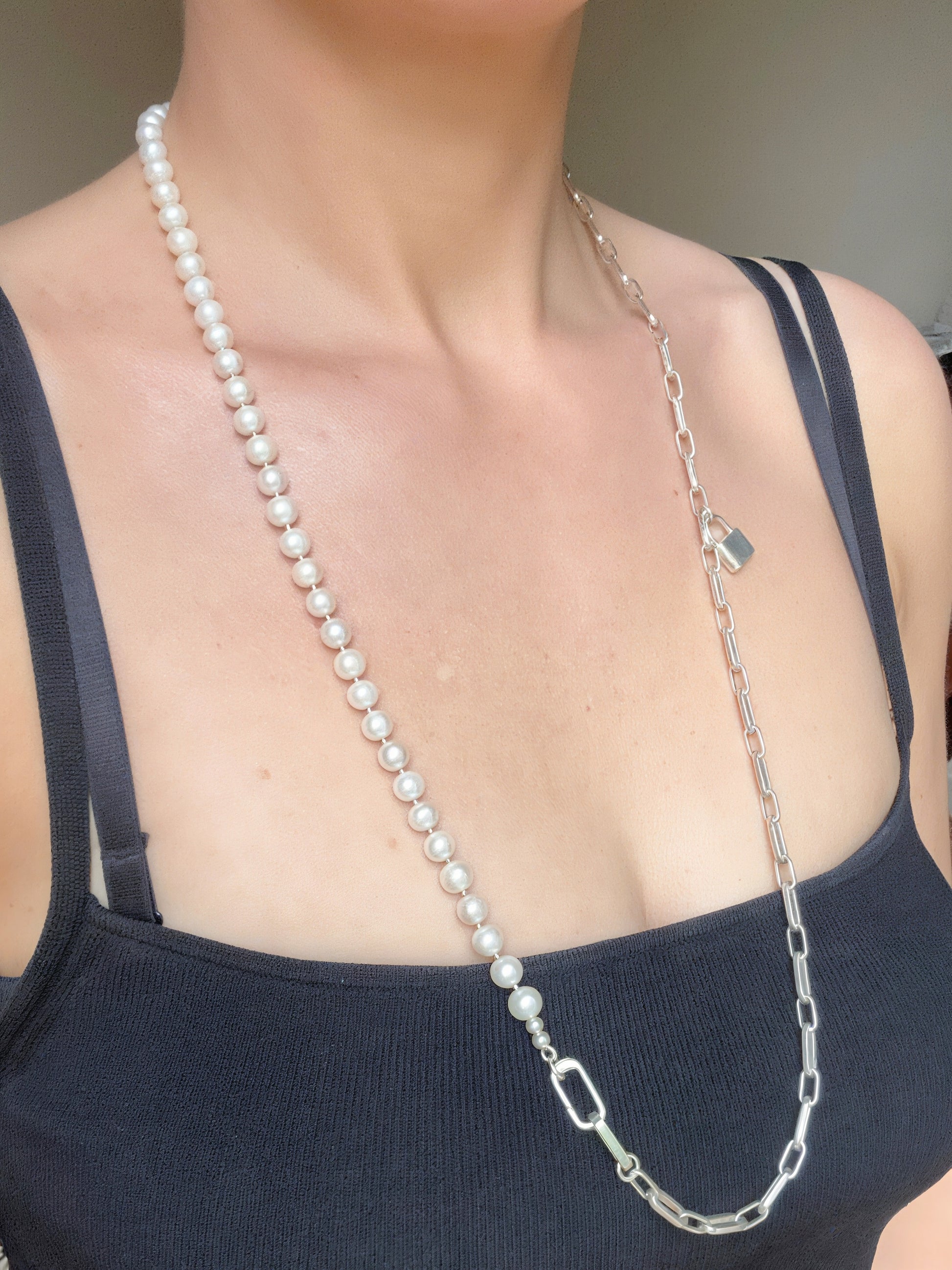 woman wearing long chain and pearl necklace