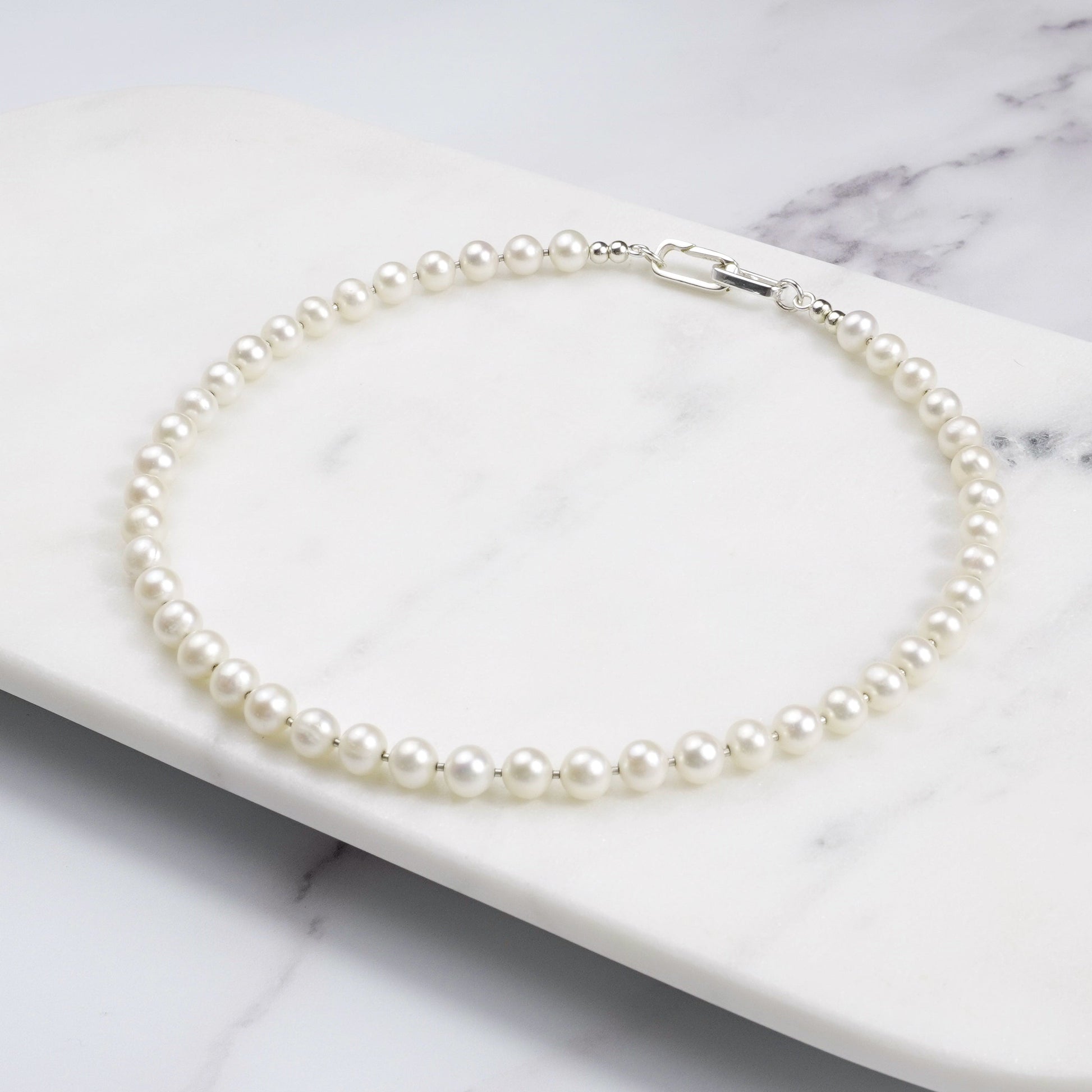 Pearl necklace on a marble surface